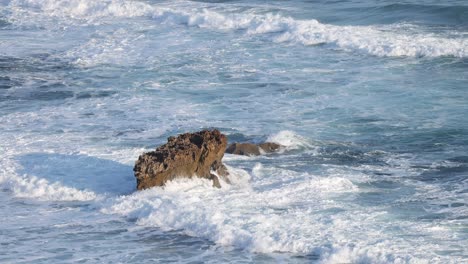 waves crashing against a rock formation