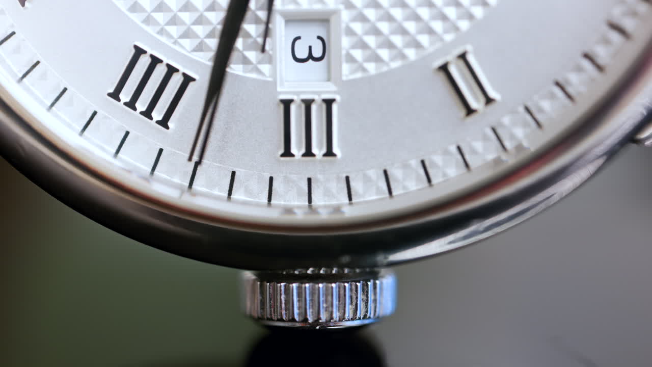 Close up of a silver watch on a blurred background