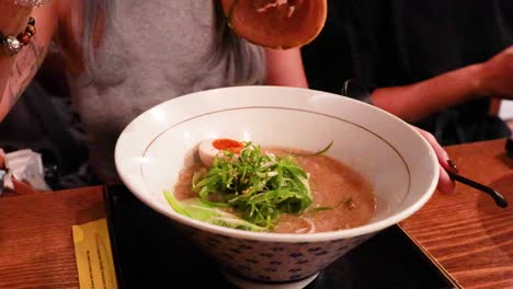 person savoring ramen with chopsticks in australia