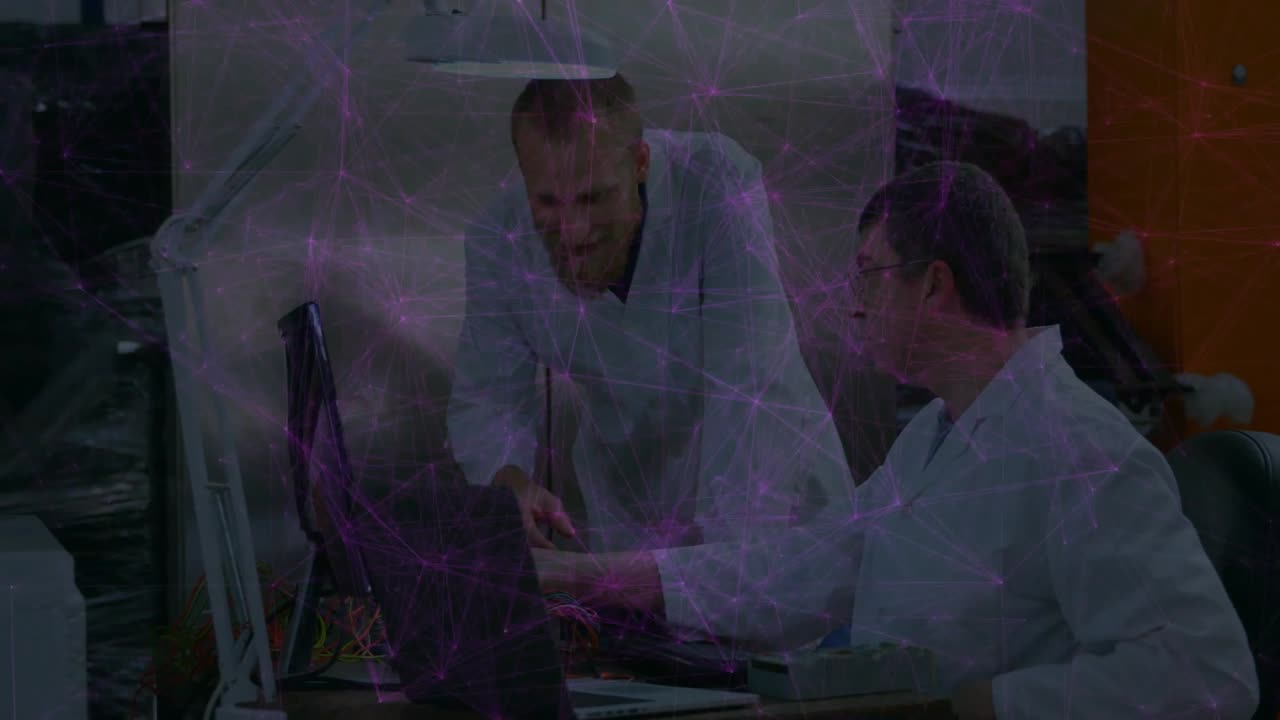Pointing at laptop screen, engineers revealing circuit board and tracing wires for electronics test