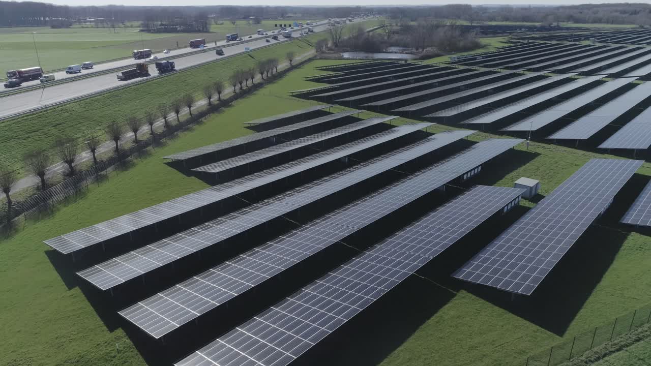 Very high aerial drone shot of solar panels on a field