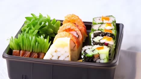 sushi platter with salmon and cucumber maki