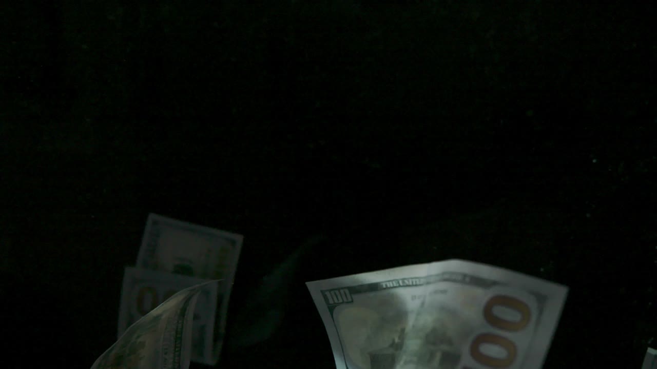 Falling flying american canadian dollar banknotes on a black background in 4K Loopable. High quality falling Dollar banknotes in 4K. Video is Loopable
