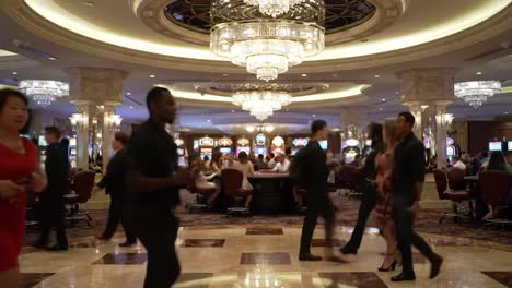 a lively night at the casino: capturing the vibrant atmosphere of gamblers and glimmering slot machines in a luxurious gaming environment