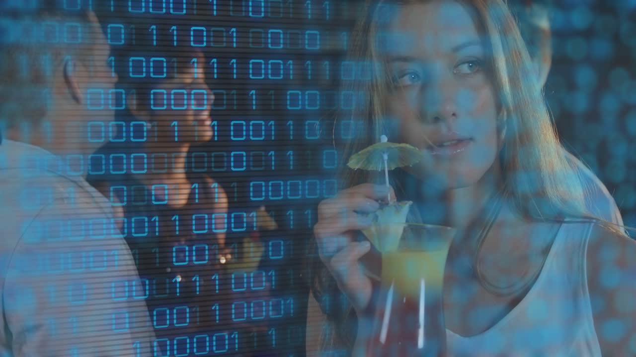Woman raising drink and moving umbrella at bar, binary digits overlaying scene, tech socializing