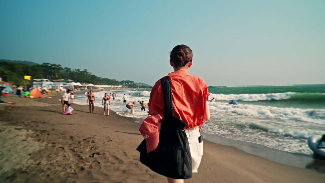 Woman on a beach with people