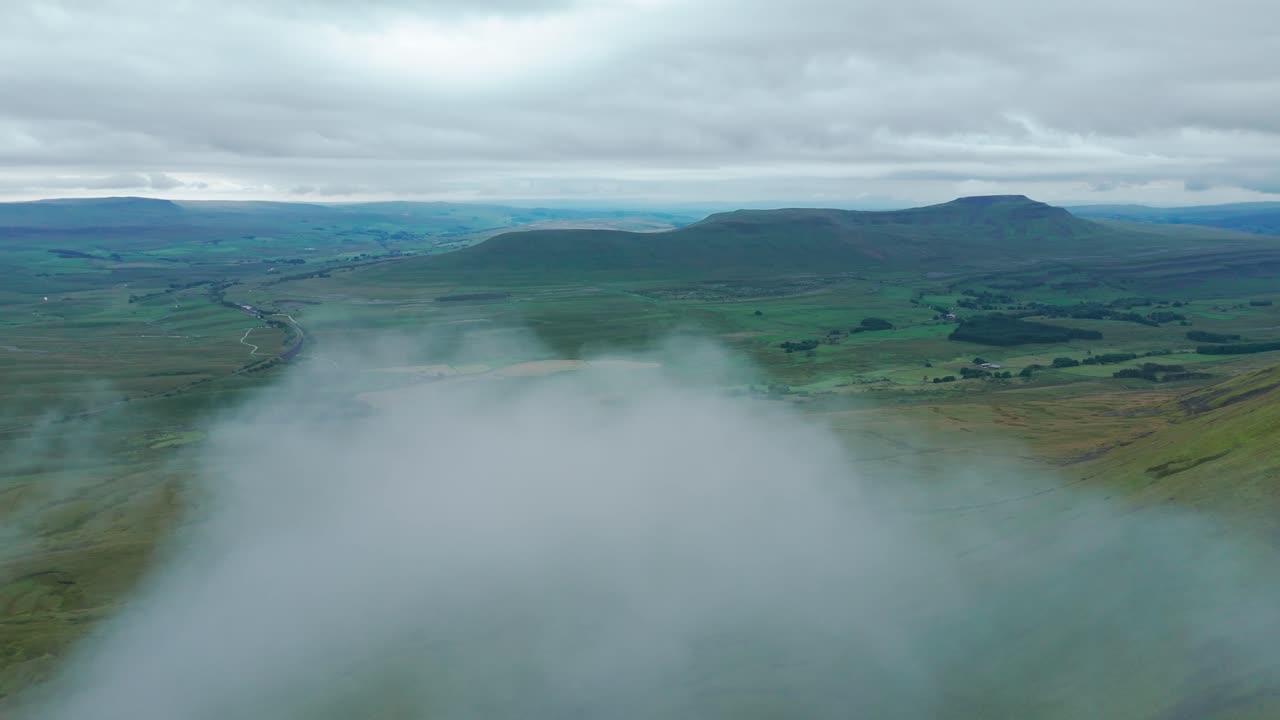 Panoramic View of Lush Green Mountains and Valley with Low-Lying Clouds