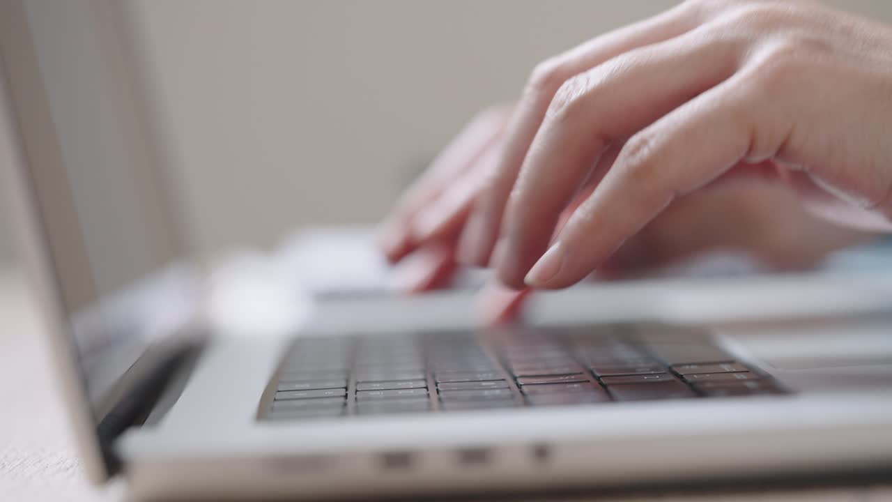 Close up Shot of Businesswoman hands typing on laptop computer keyboard for searching information,online communication support,marketing research,business report in the office desk at night.