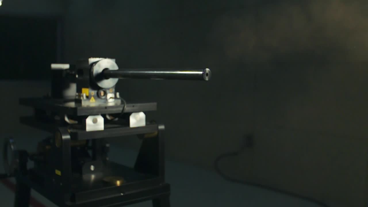 Close-up of a large black weapon on a stand