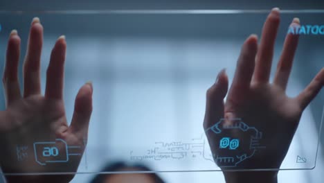 exploring digital interfaces: a close-up of hands interacting with a transparent touchscreen display in a modern tech environment