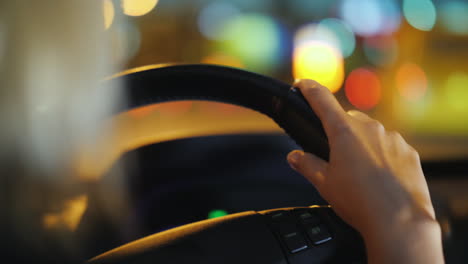 night driving in the city female hands on the steering wheel video with a shallow depth of field 4k