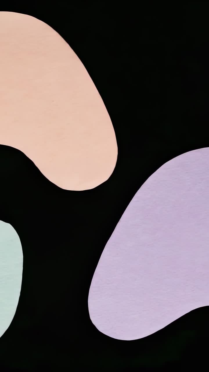 Video verticale: loop di blob color pastello che ricominciano a fluttuare sul nero, nei colori pesca, lavanda, verde menta