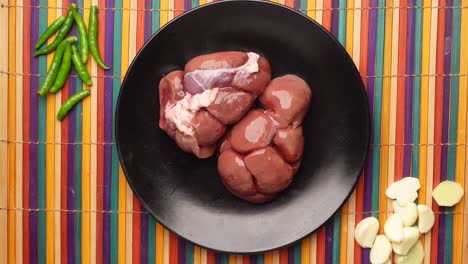 Raw-fresh-lamb-kidneys-on-a-chopping-board-,