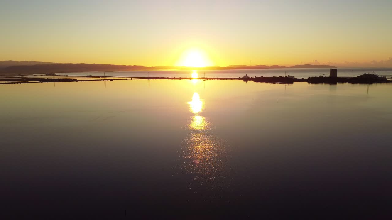 Peaceful scenery of sun rising above hills in Sant'Antioco, aerial drone, static