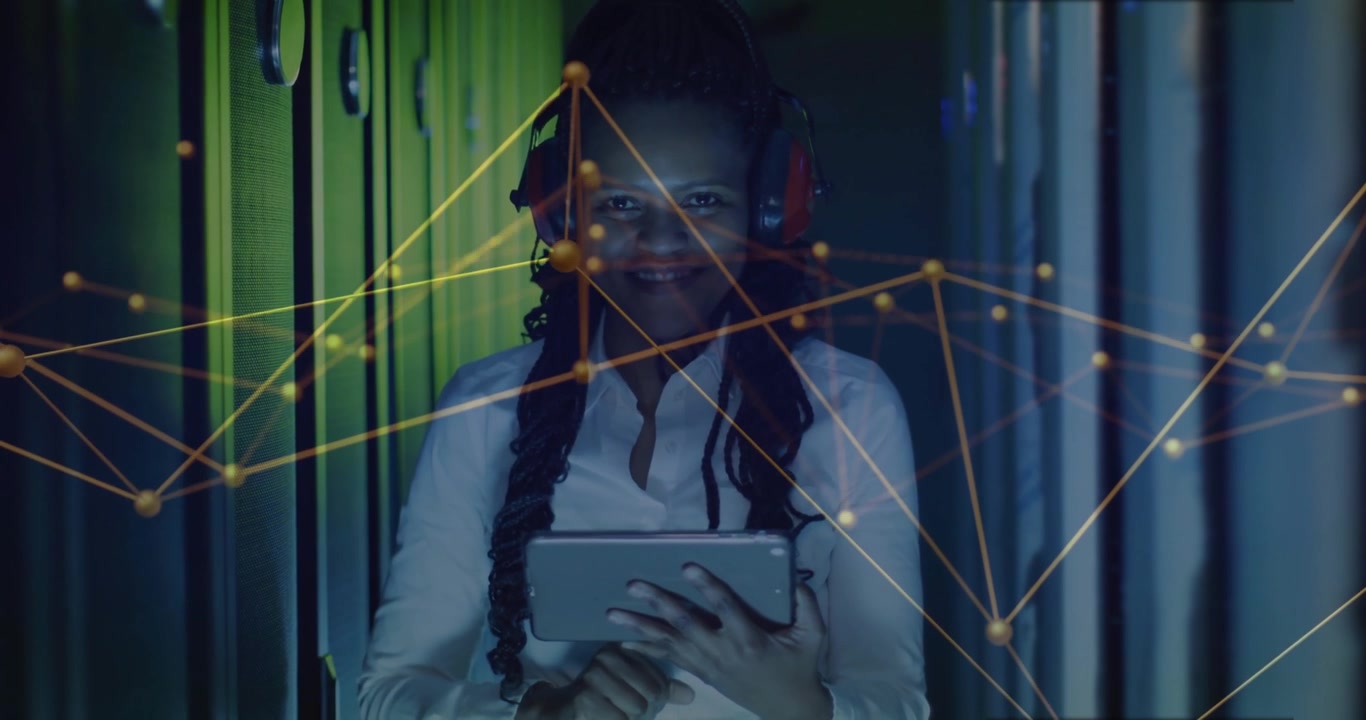 IT specialist woman tapping tablet initiating network overlay and analyzing network in data center