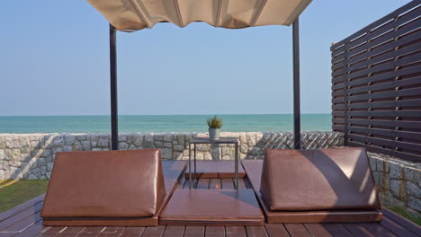 A-cabana-set-up-with-padded-massage-tables-faces-the-ocean-horizon