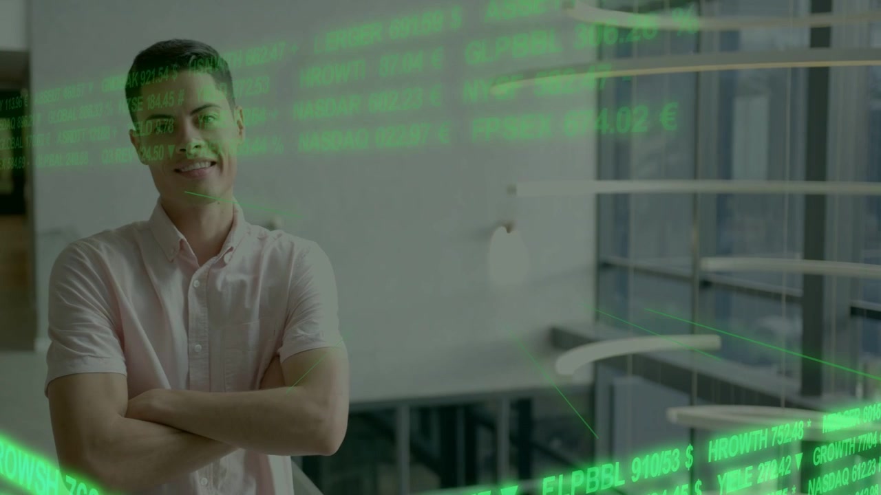 Adult male standing atrium scrolling finance ticker obscuring face turning crossing arms smiling