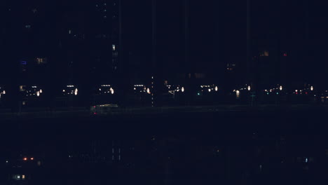 vehicles traveling on the bridge near city port during dusk