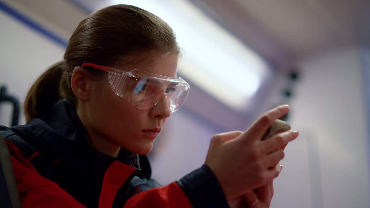 Doctor scrolling phone in emergency vehicle. Paramedic browsing internet online