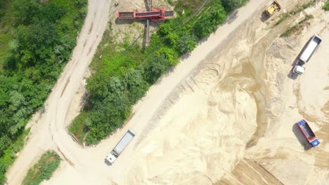 Aerial-view-loading-bulldozer-in-open-air-quarry