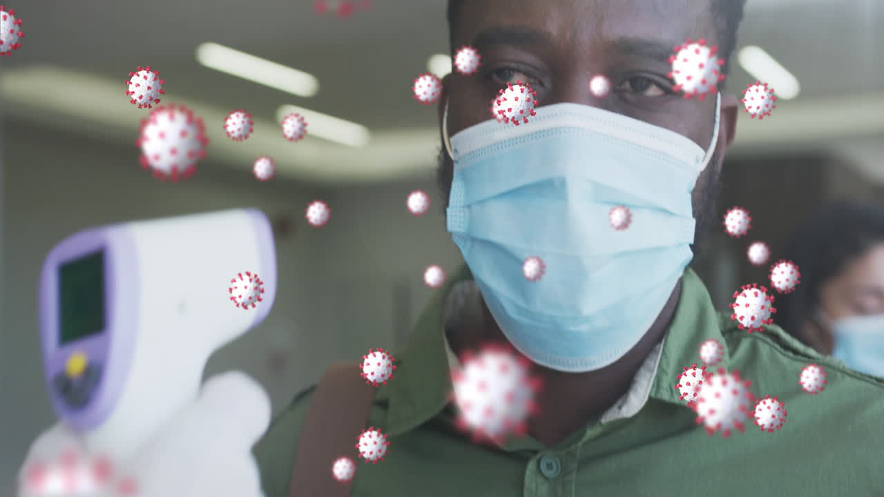animación de células de covid-19 flotando con un hombre que tiene la temperatura comprobada usando máscaras faciales