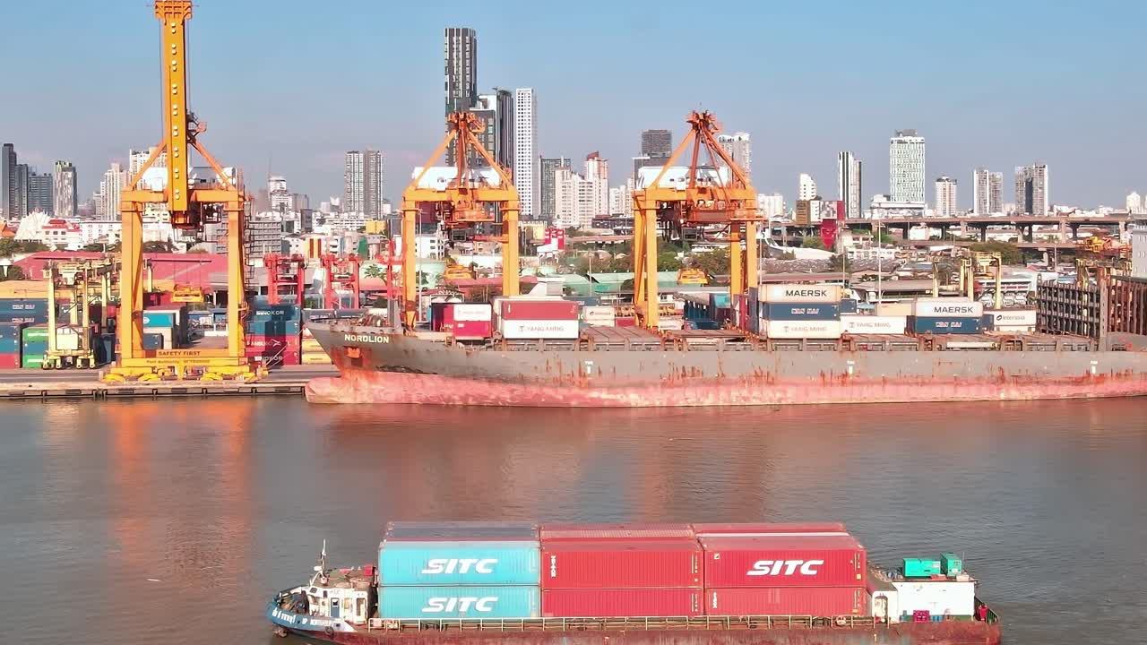 Ships and cranes are busy at work at a shipping port in Bangkok