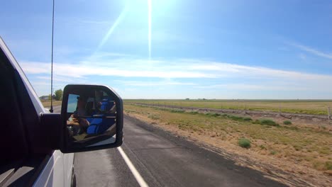 POV-out-of-the-passenger's-side-window-while-driving-through-an-agricultural-area-of-Eastern-Washington-State