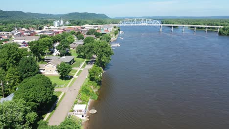 aerial view of a river town with a bridge