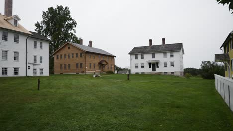 A-slow-panning-shot-reveals-colorful-houses-in-a-historical-shaker-village-in-New-Hampshire