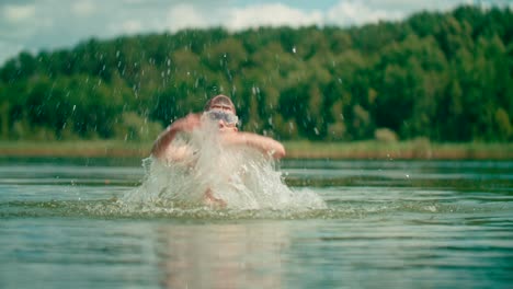 kid with swimwear in the lake splashing water with both hands