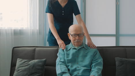 old man sitting alone, young caring nurse woman talks to him