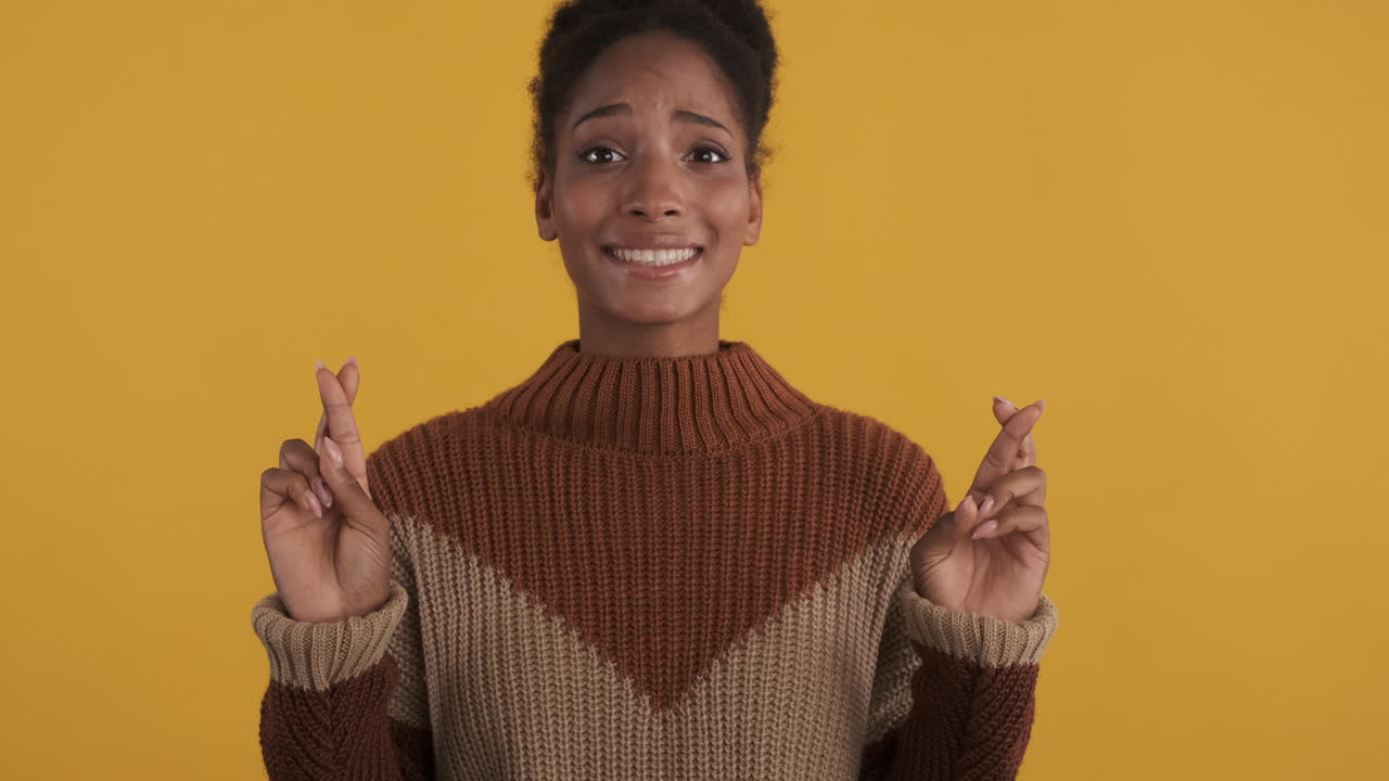 Excited woman crossing fingers