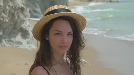 smiling woman in a hat on the beach