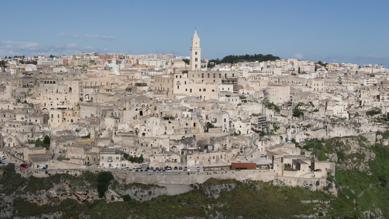 Panning reveal view of ancient old city Matera exterior facade with historic buildings