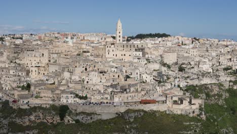 panning reveal view of ancient old city matera exterior facade with historic buildings