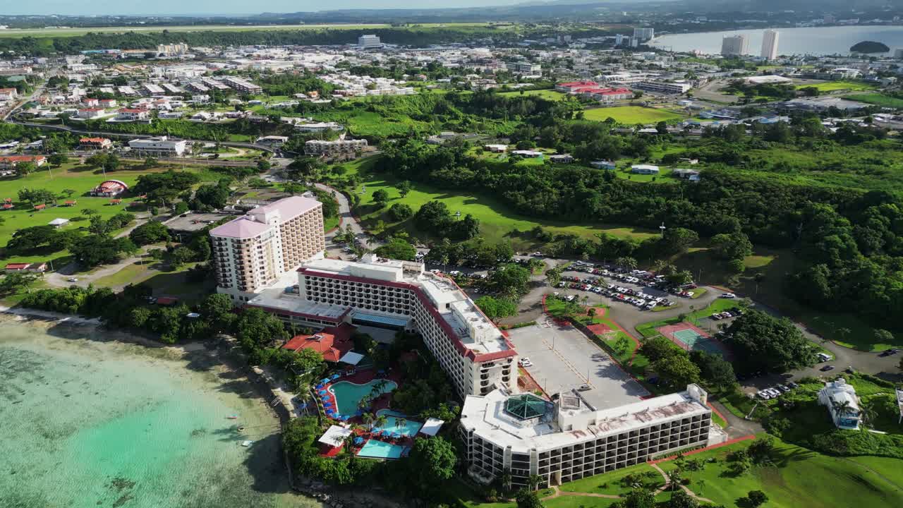 Picturesque aerial overview of Guam Hilton Resort Hotel and Spa along scenic coastal waters in a tropical island