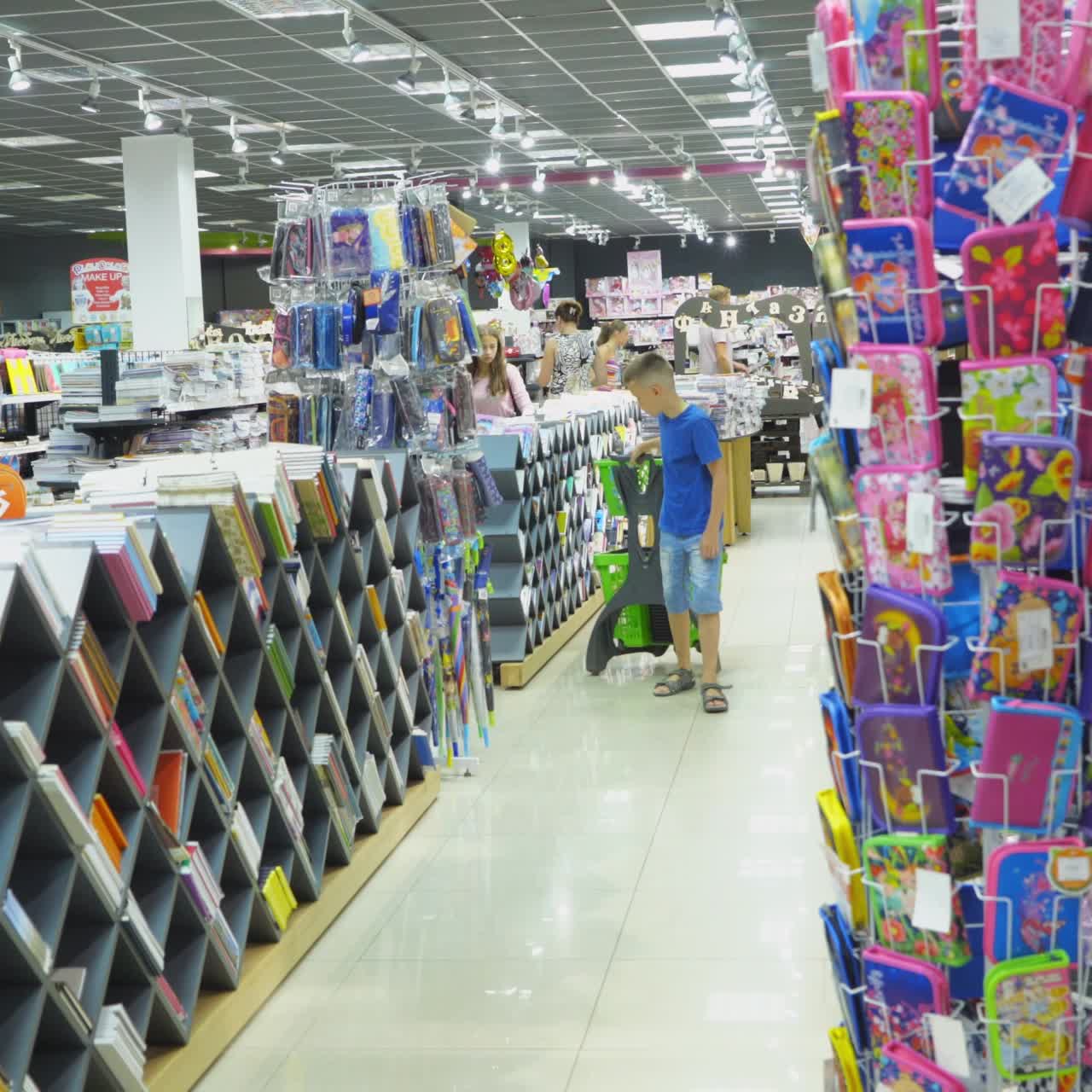 VINNITSA, UKRAINE - AUGUST 20, 2018: Boy choosing school stationery at a supermarket. Back to School