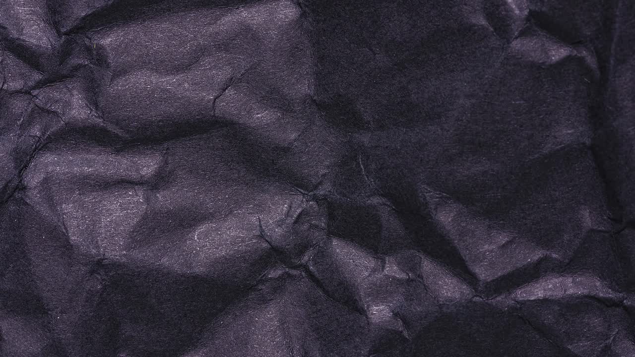 Stop motion of wrinkled black paper texture, seamless loop