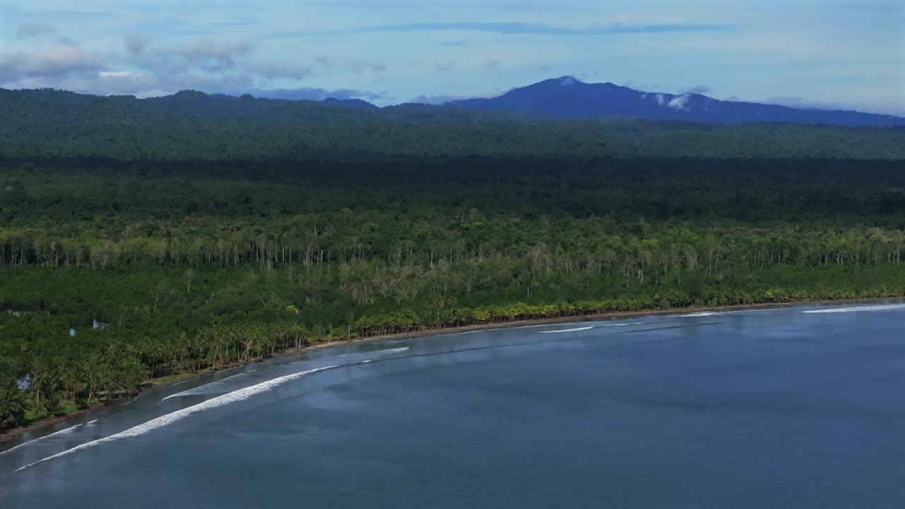 Wewak waves sea harbour view Wewak Hill Cape Wom Dogreto aerial drone Papua New Guinea Pacific Ocean pristine remote tropical beach coastline sunny dry season blue sky morning mountains forward pan up