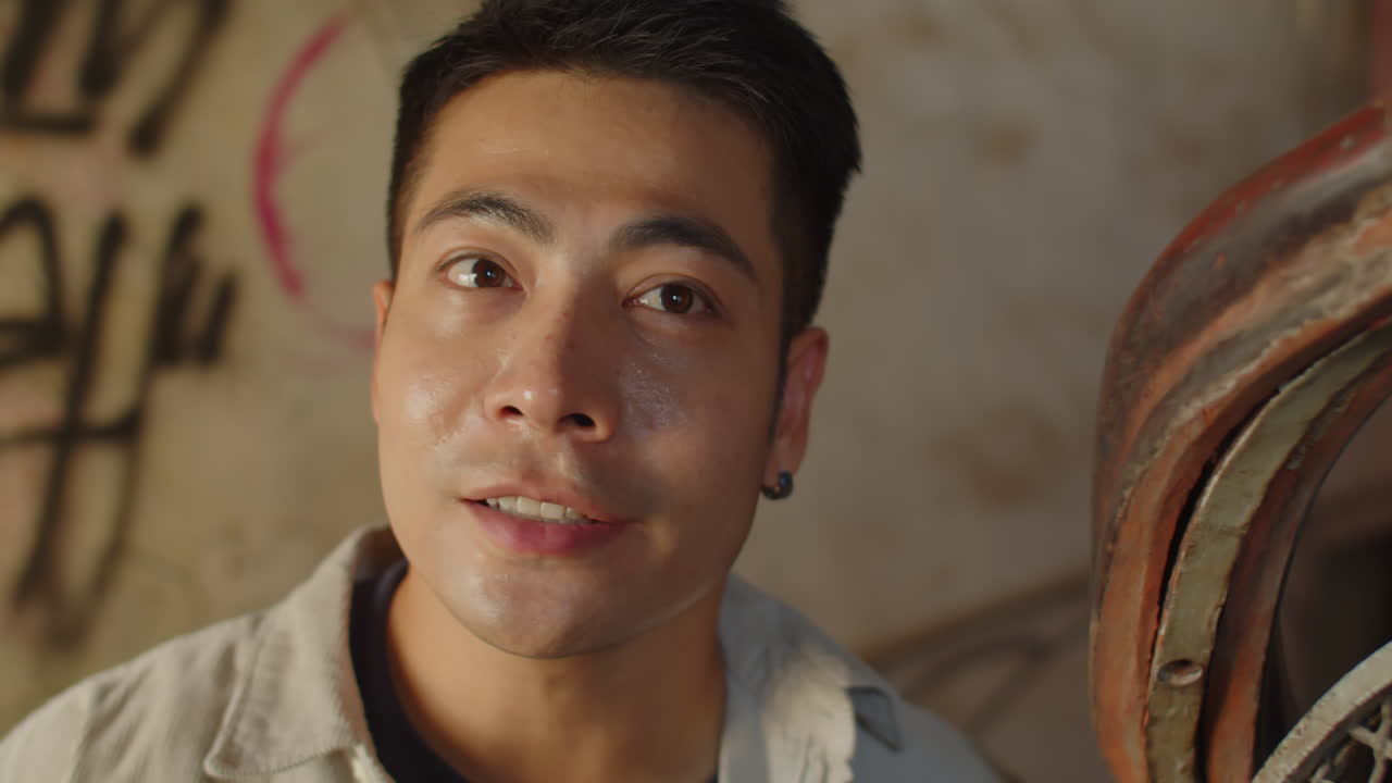 Excited Asian Man Taking Pictures inside Abandoned House