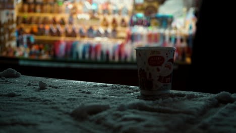 styrofoam cup on a snowy table at tallinn christmas market