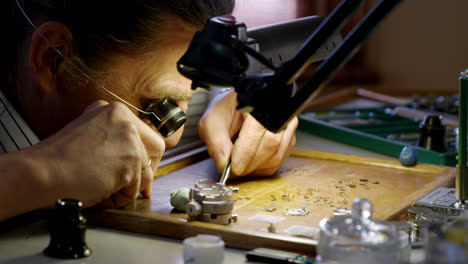 close-up of horologist repairing a watch