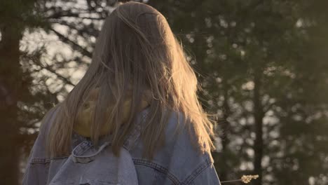 beautiful girl walking on the sunset in forest