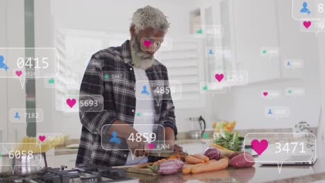 Animation-of-notification-bars-over-senior-african-american-man-cutting-vegetable-in-kitchen-at-home