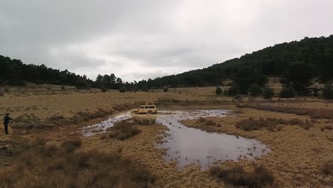 classic offroad car crossing puddle