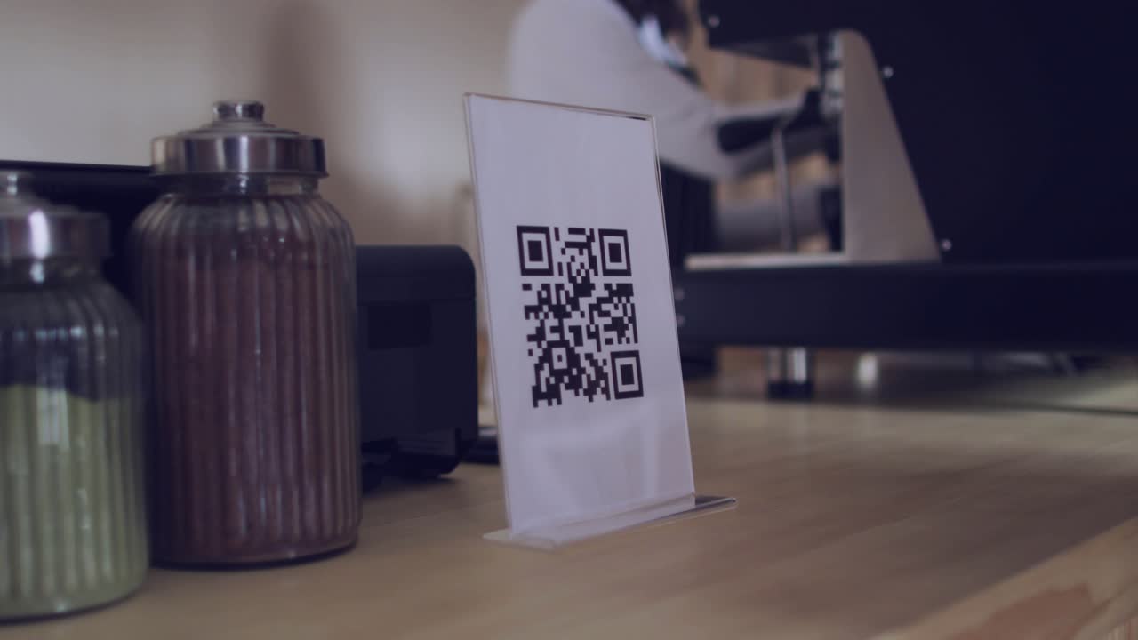Woman's hands aligning phone over QR sign on cafe counter, overlay scrolling, opening menu