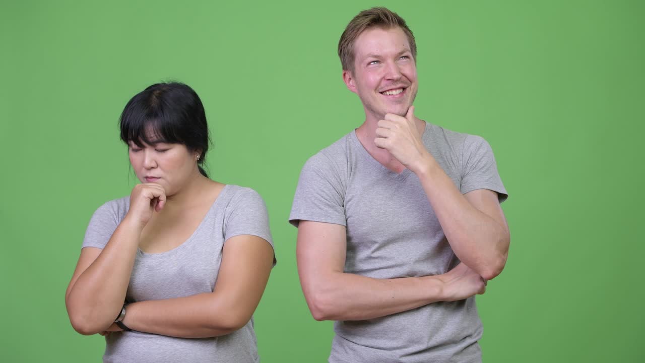 Young multi-ethnic couple thinking differently together