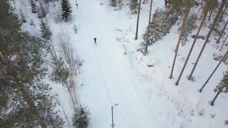 long distance skier top down view, drone shot descending