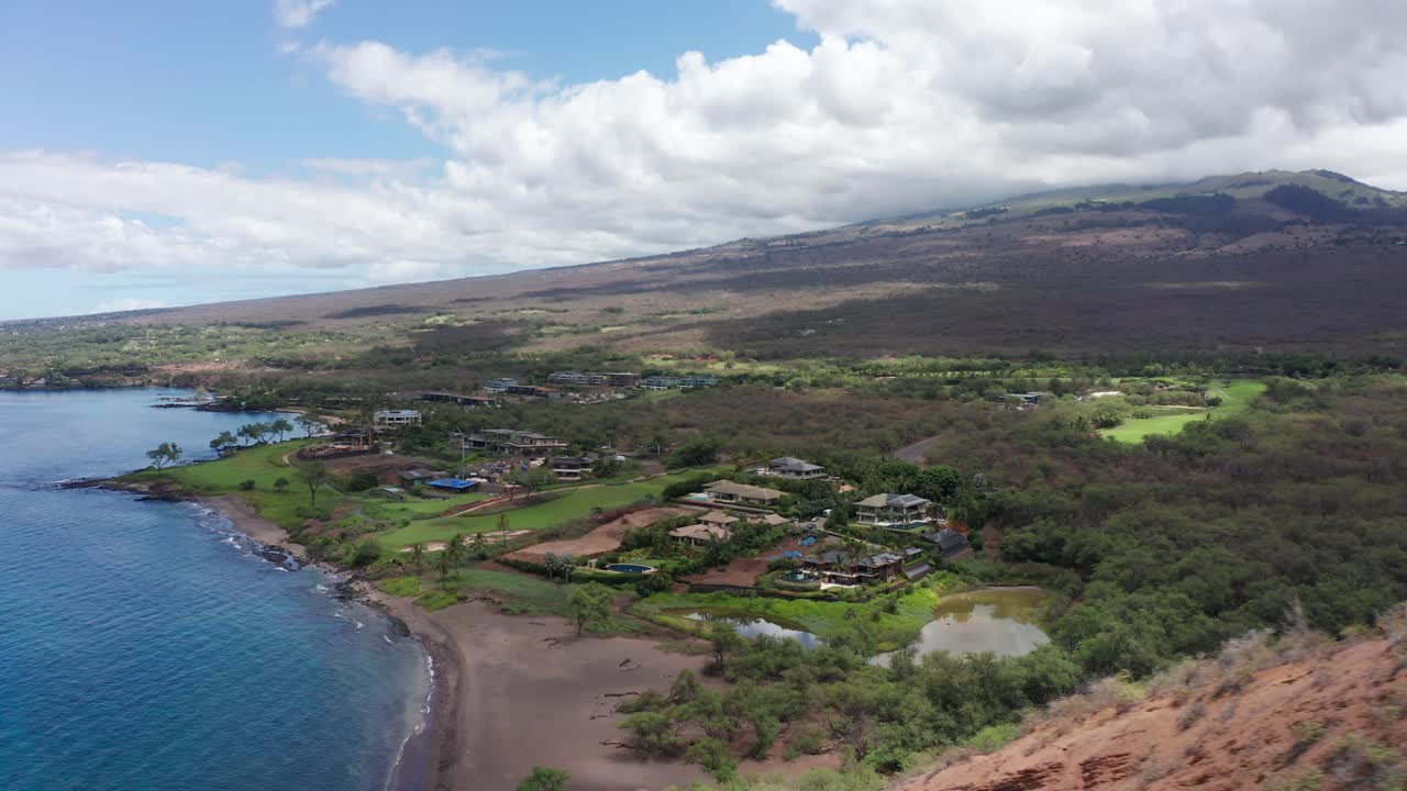 Low aerial shot flying over scenic Maluaka Beach, home of Turtle Town, along the southern coast of Maui in Hawai'i
