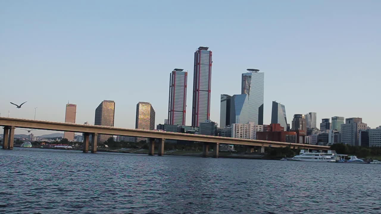 City Skyline with River and Bridge